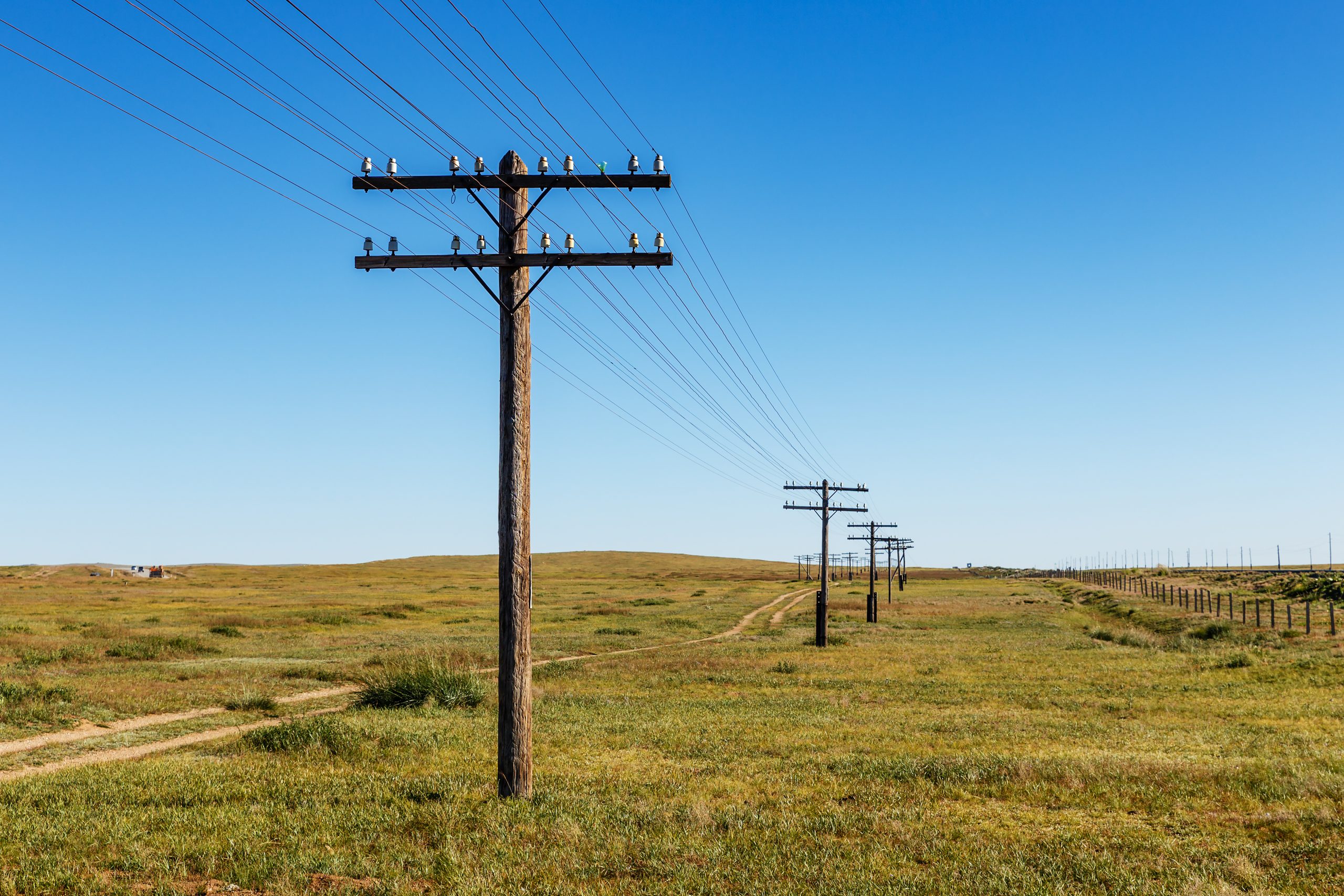overhead line on wooden supports in the Mongolian steppe overhead line on wooden supports in the Mongolian steppe, Bayan, Mongolia