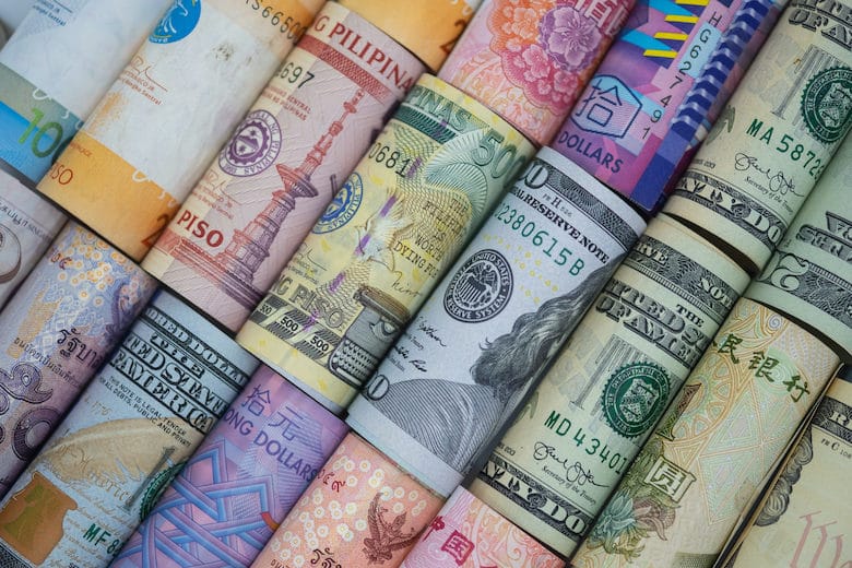 Closeup rolled of variety banknote around the world. Exchange rate and Forex investment concept.-Image.